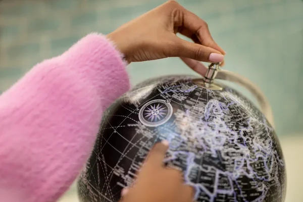 hand on globe.