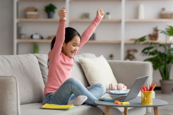 happy girl learning on a computer.