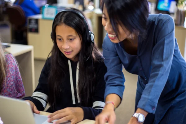 teacher helping girl.